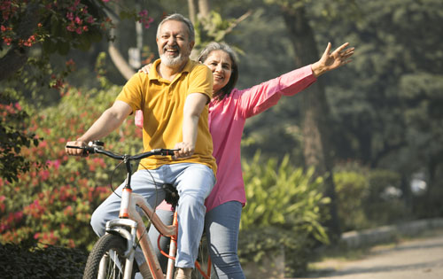 A man and a woman riding a bike