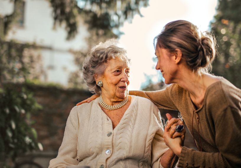 Older woman talking to a younger woman